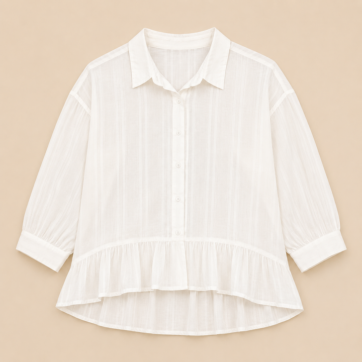 White blouse with ruffled hem on a beige background