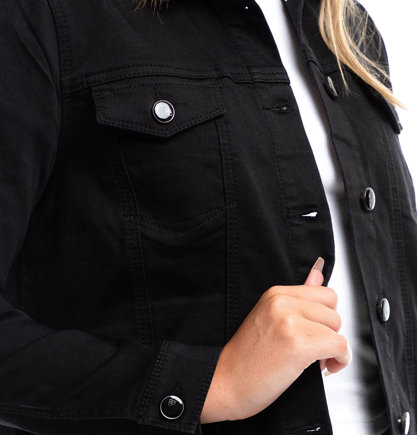 Close-up of a person wearing a black jacket showing black buttons on a white background