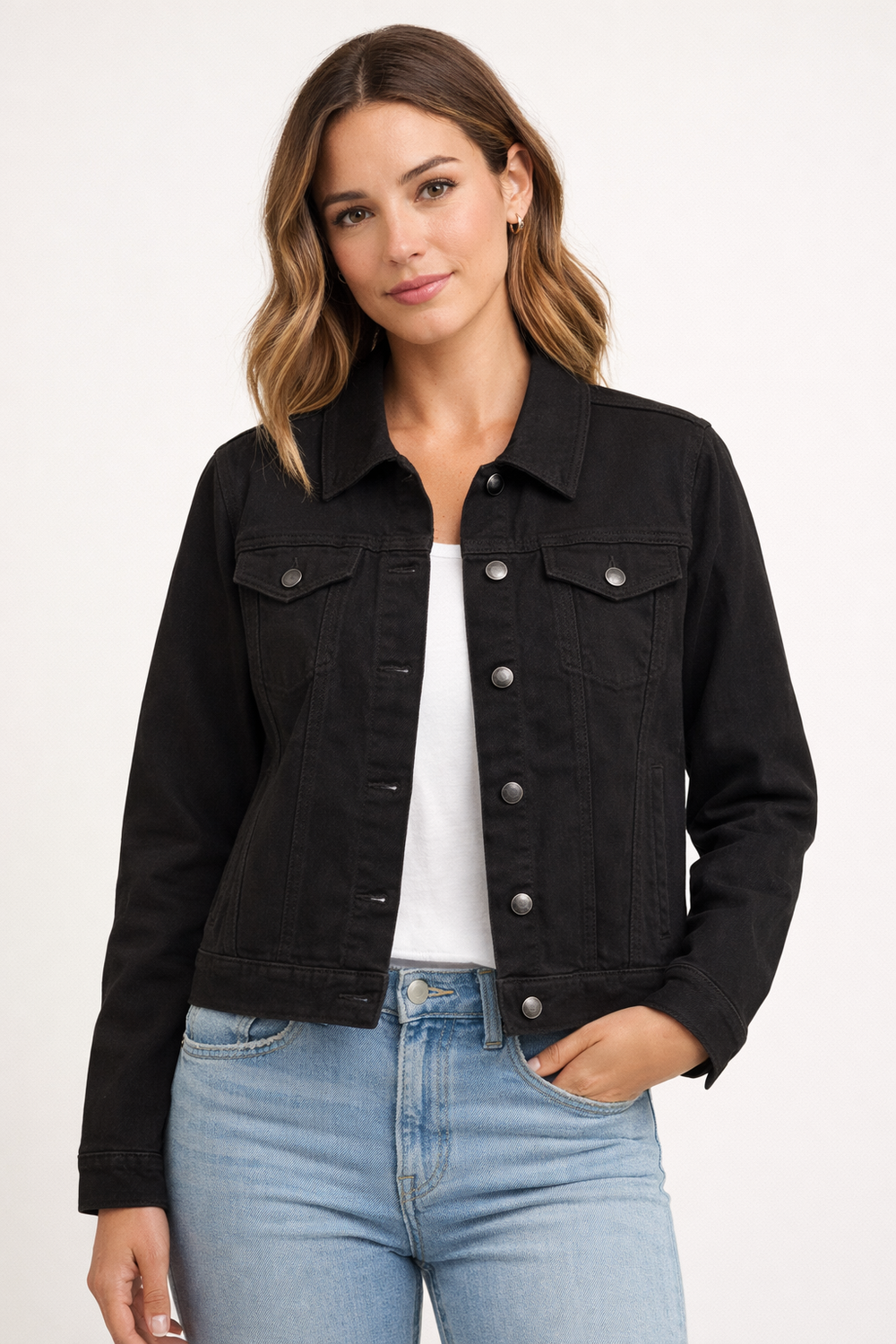 Woman wearing a black denim jacket and light blue jeans on a white background
