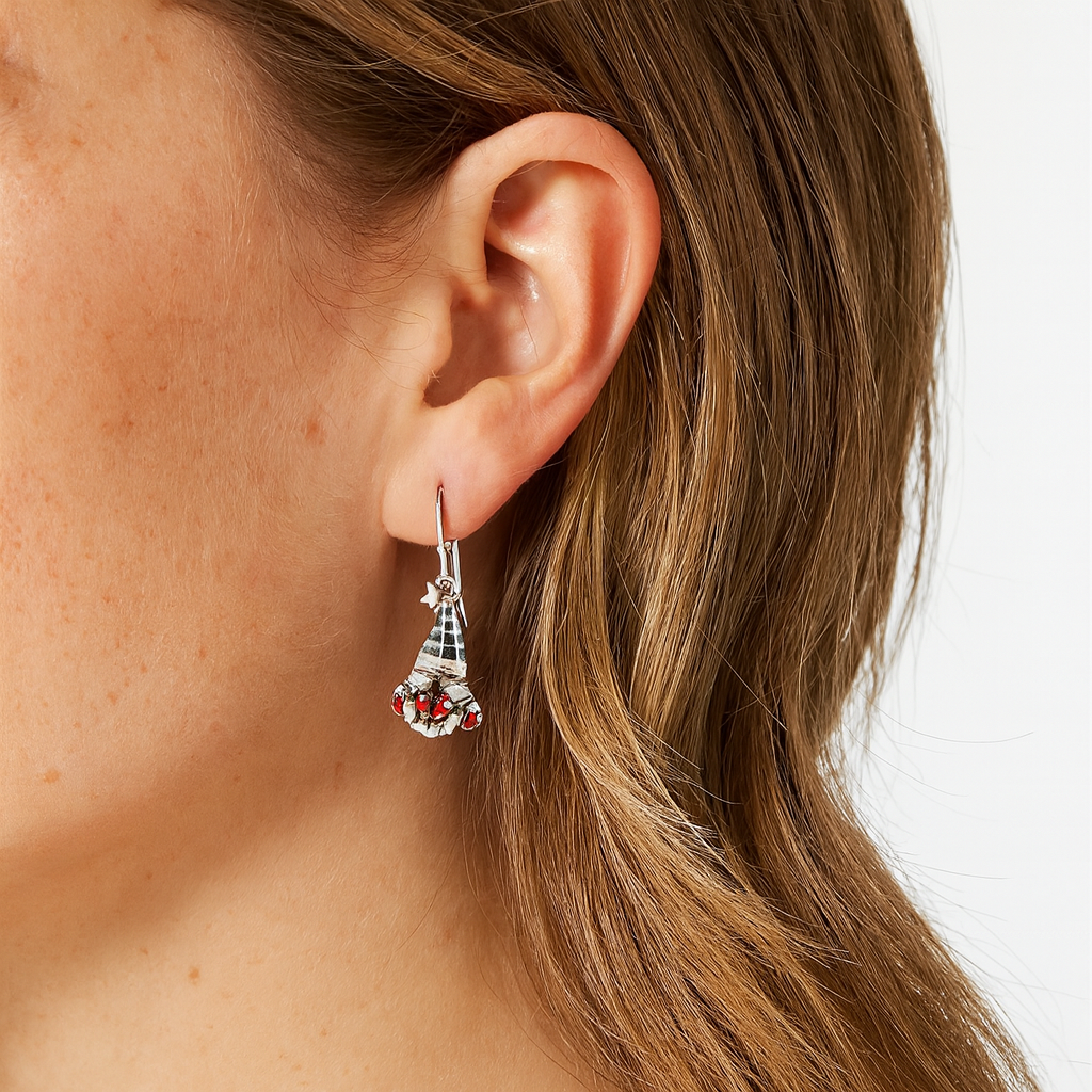 Close-up of an ear wearing a decorative earring with a white background