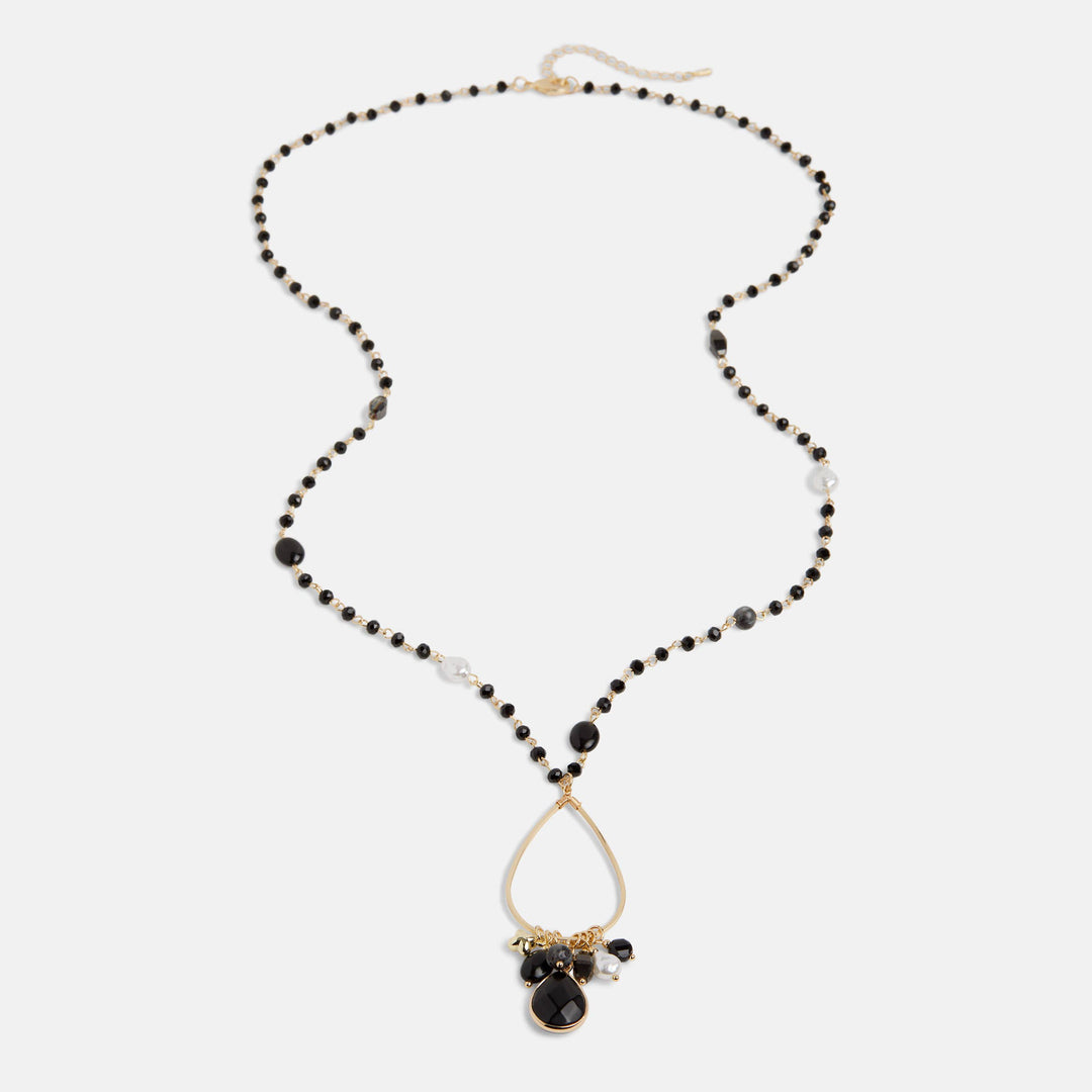 Necklace with black beads and a teardrop pendant on a white background