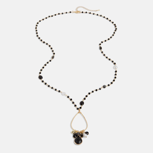 Necklace with black beads and a teardrop pendant on a white background