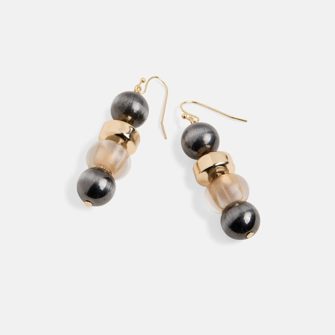 Pair of earrings with black and gold beads on a white background