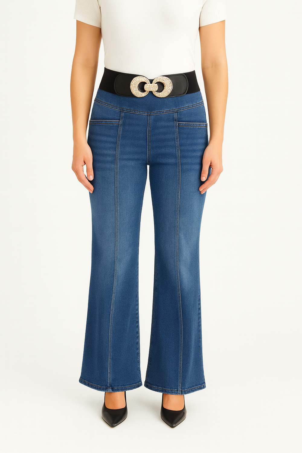Person wearing blue flared jeans with a belt on a white background