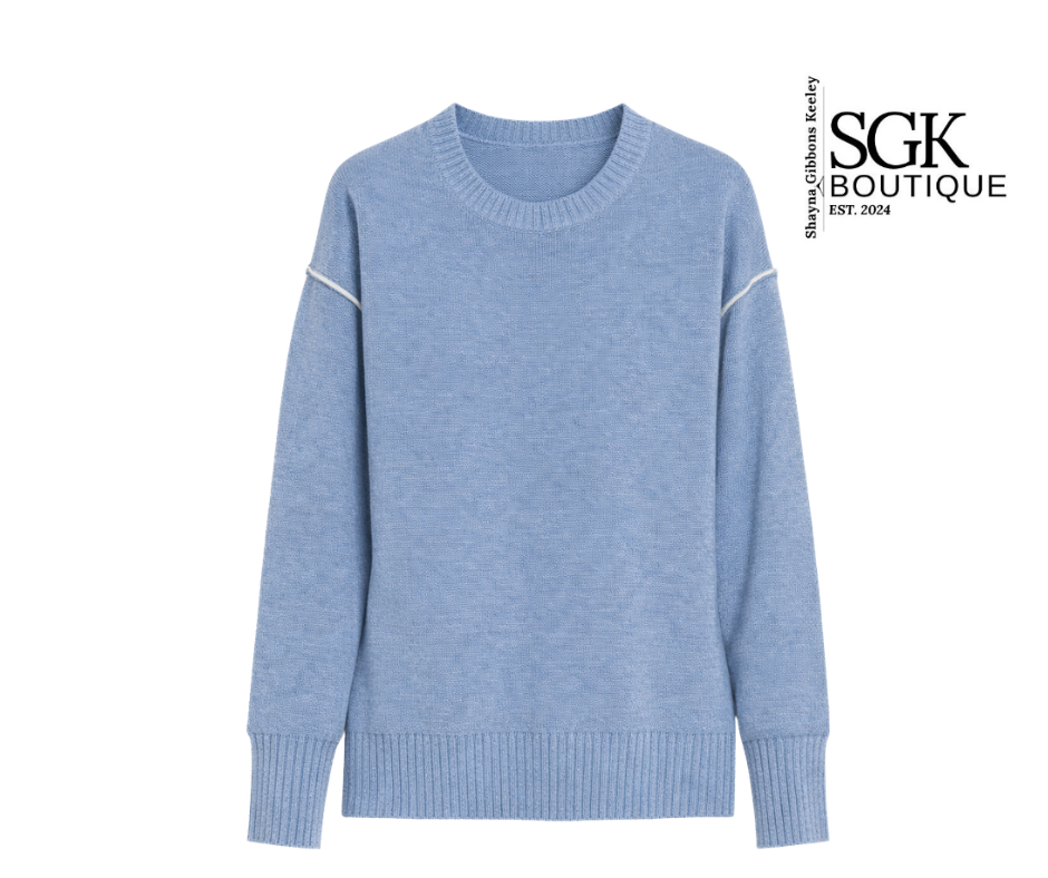 Blue sweater with white accents on a white background, featuring the SGK Boutique logo.
