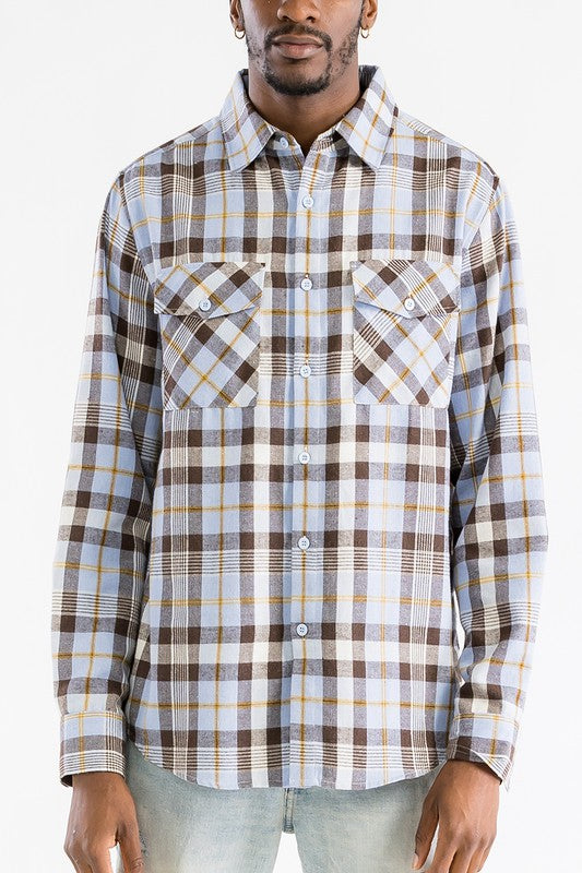 Man wearing a plaid shirt with a white background