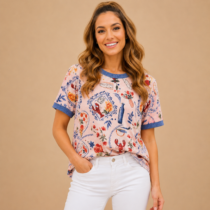 Woman wearing a patterned blouse with white pants against a beige background