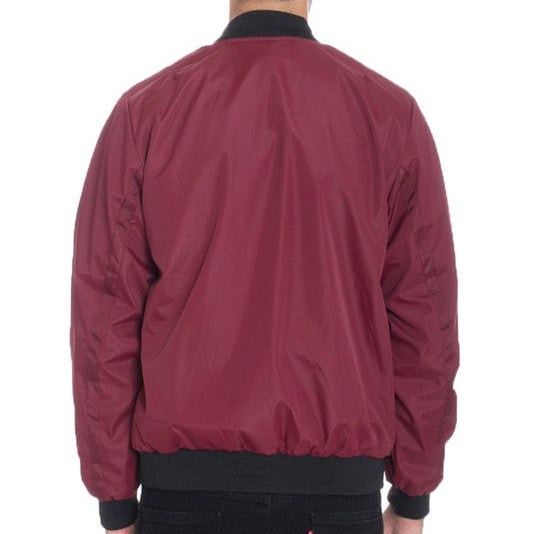 Maroon bomber jacket worn by a person on a white background