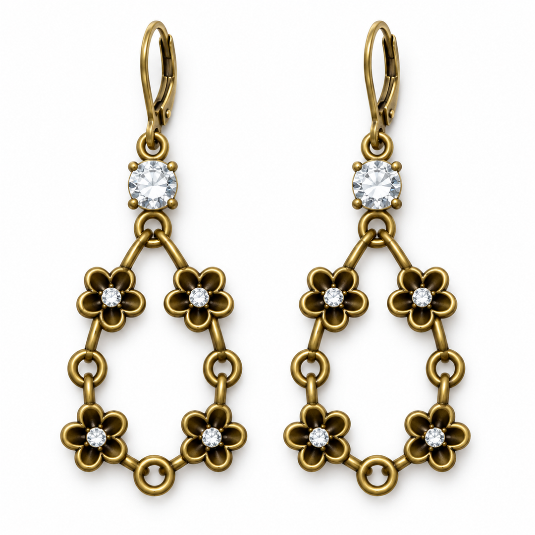 A pair of gold drop earrings with leverback hooks, featuring a square clear crystal at the top and three tiers of flower-shaped links, each accented with a small round clear crystal, shown on a plain white background.