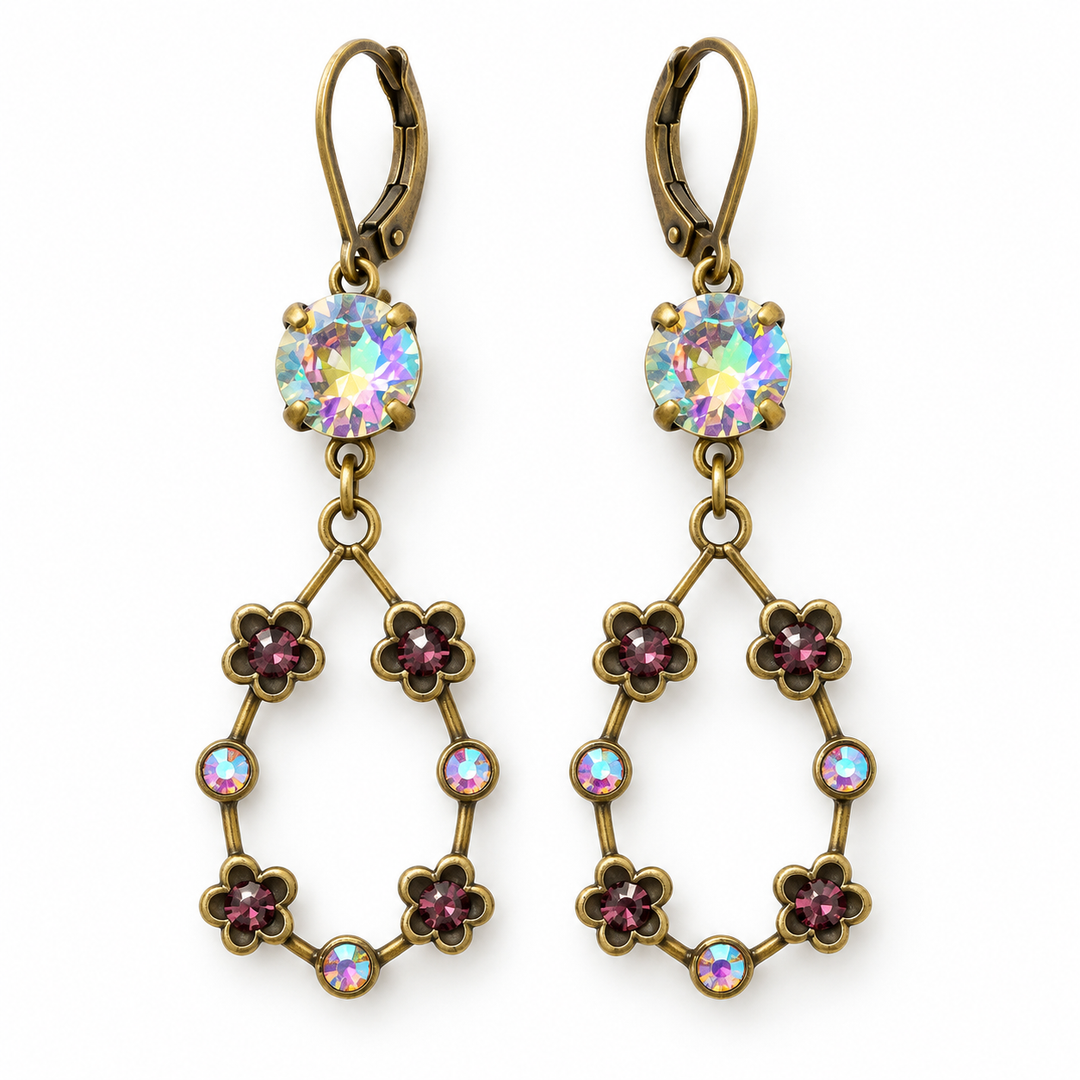 A pair of antique bronze drop earrings featuring a round iridescent crystal at the top and a dangling teardrop-shaped frame adorned with small pinkish-purple flower motifs and round iridescent crystals, shown on a plain white background.