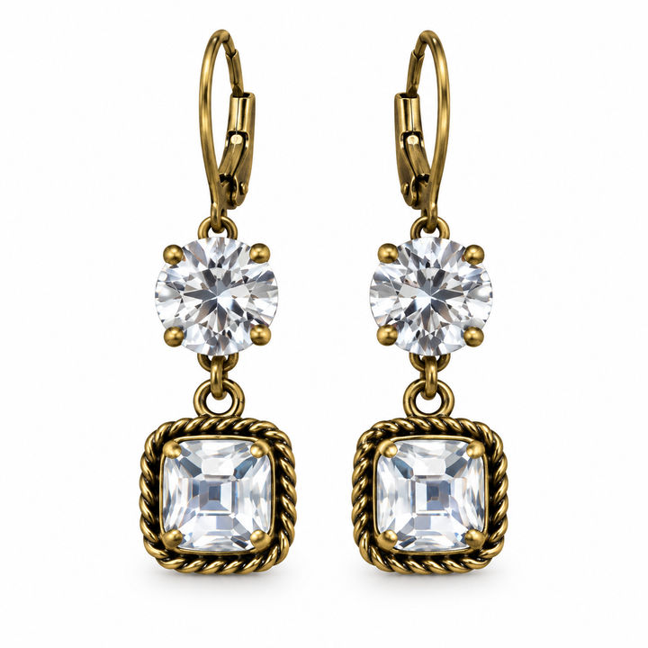 A pair of gold leverback drop earrings featuring a round clear crystal and a square bezel-set clear crystal with a twisted rope border, shown on a plain white background.