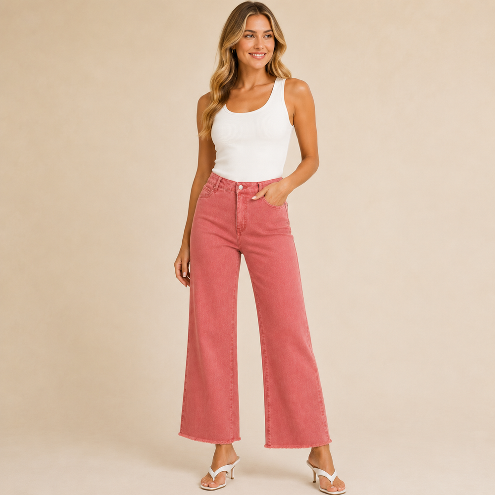 Woman wearing pink jeans and a white top on a beige background