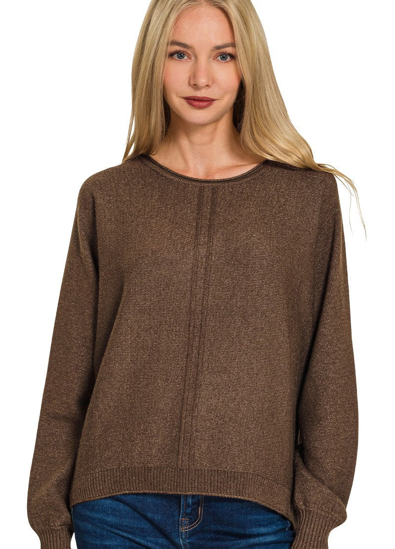 Woman wearing a brown sweater on a white background