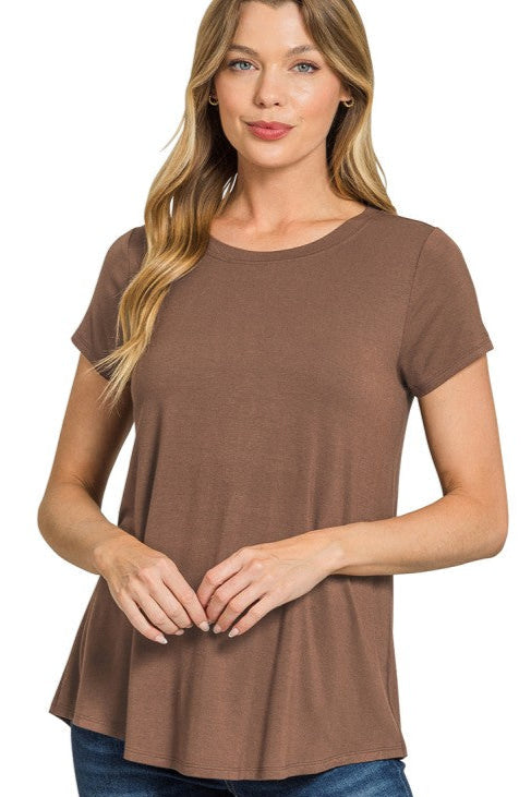 Woman wearing a brown t-shirt and blue jeans on a white background