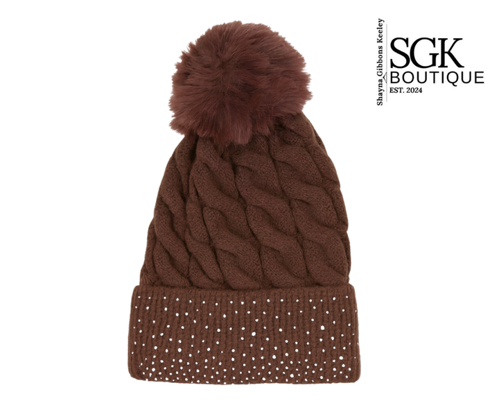 Brown knit beanie with pom-pom and crystal details on a white background, featuring SGK Boutique logo.