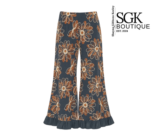 Floral-patterned pants on a white background with SGK Boutique branding.