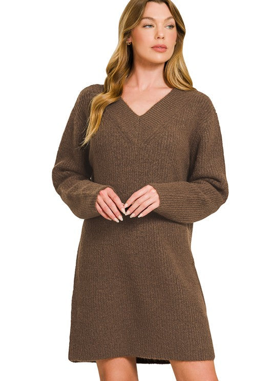 Woman wearing a brown sweater dress on a white background