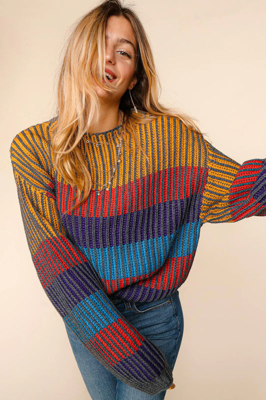 Woman wearing a colorful striped sweater against a beige background