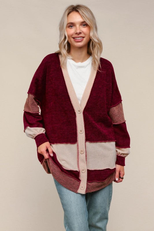 Woman wearing a burgundy and beige cardigan on a beige background
