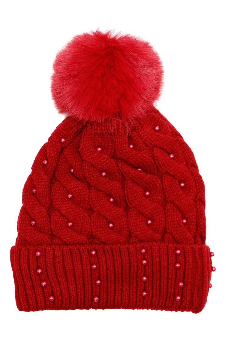 Red knitted beanie with a large pom-pom on a white background