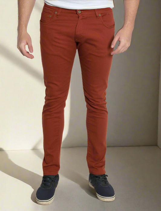 Person wearing rust-colored pants on a white background