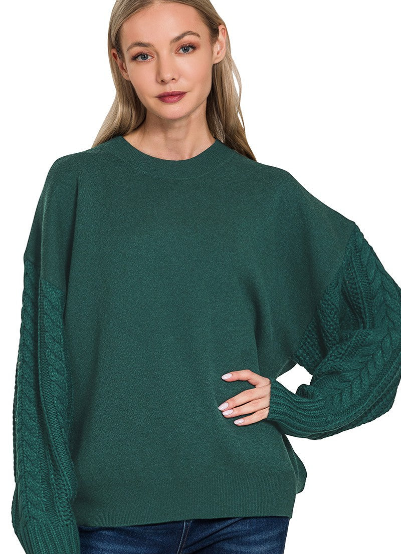 Woman wearing a hunter green sweater on a white background