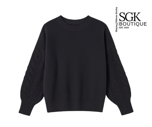 Black sweater on a white background with SGK Boutique logo.