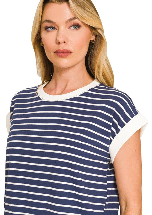 Woman wearing a navy and white striped shirt on a white background