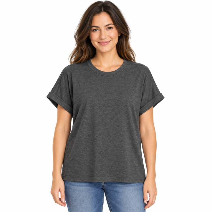 A woman wearing a dark heather gray short-sleeve t-shirt with rolled cuffs and blue jeans, standing against a plain white background.
