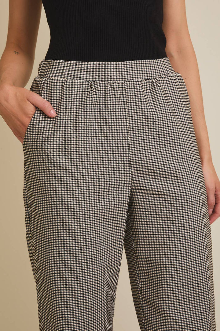 Person wearing plaid pants with a plain background