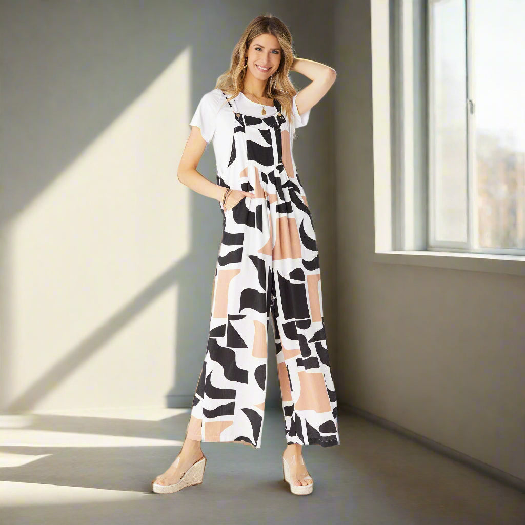 Woman wearing a black and white patterned jumpsuit on a white background