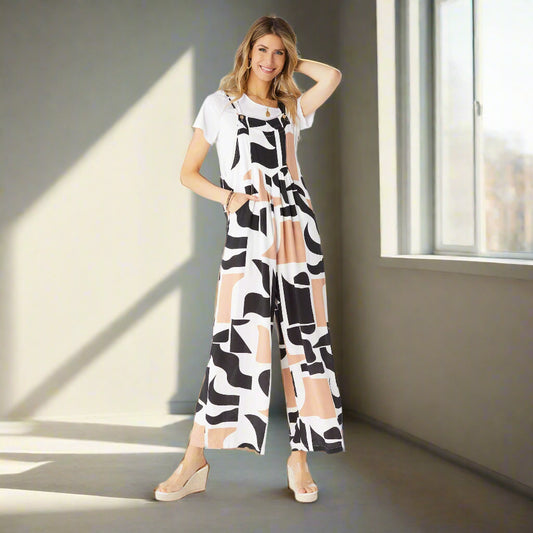 Woman wearing a black and white patterned jumpsuit on a white background