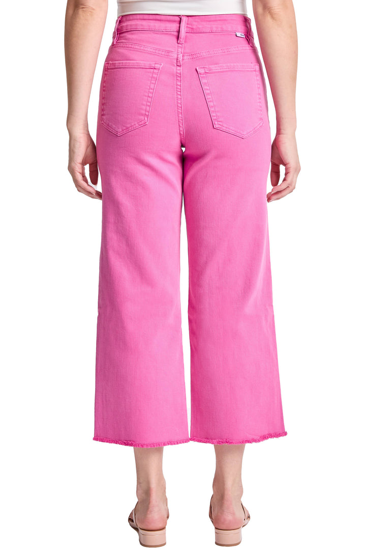 Person wearing bright pink wide-leg jeans on a white background