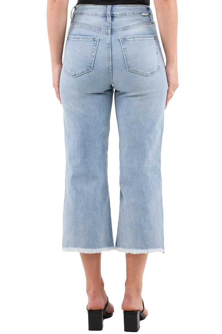 Light blue jeans worn by a person on a white background