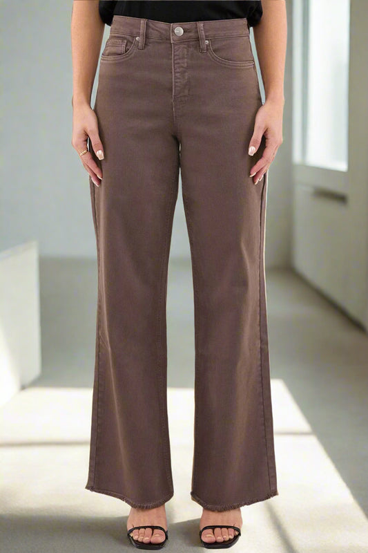 Brown wide-leg jeans worn by a person on a white background