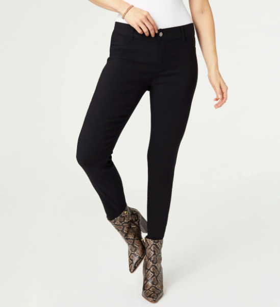 Person wearing black pants and patterned boots on a white background