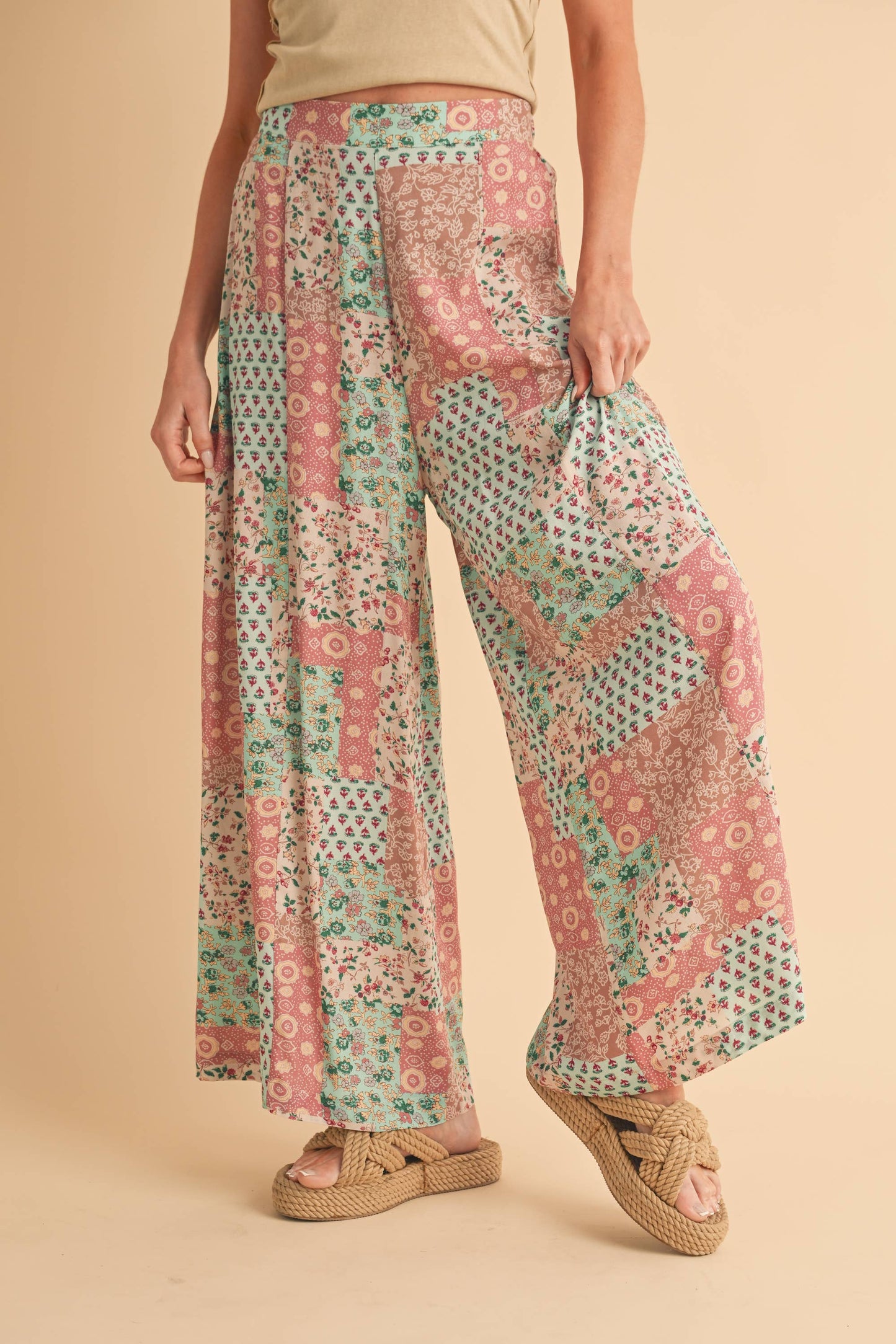 Person wearing patterned pants on a beige background