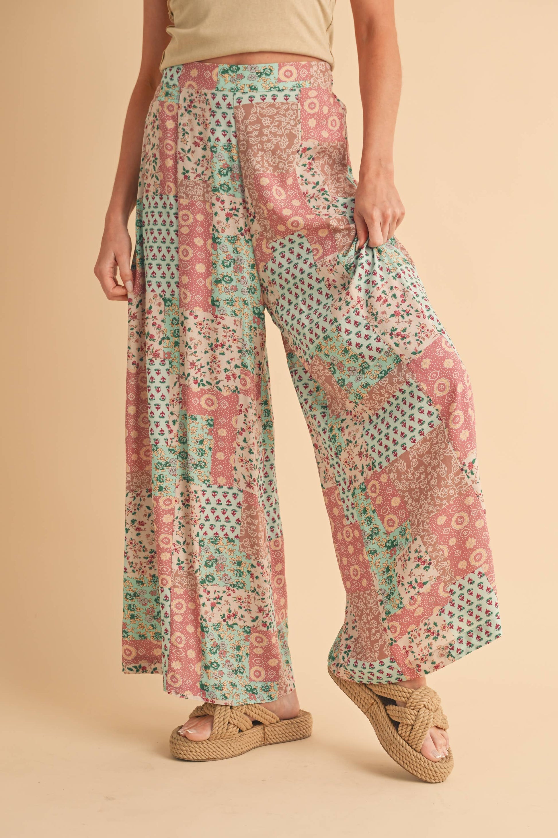 Person wearing patterned pants on a beige background