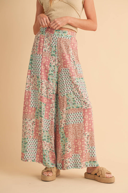 Person wearing a patterned pant on a beige background