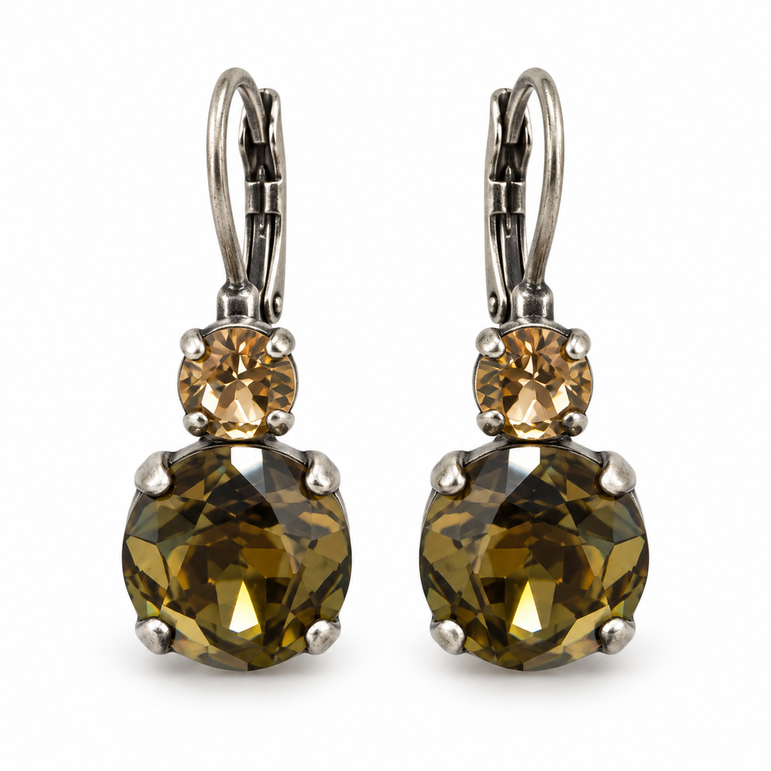 A pair of leverback earrings featuring large faceted olive-green gemstones and smaller round champagne-colored stones, set in silver-tone metal on a white background.
