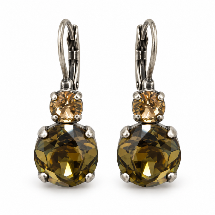 A pair of leverback earrings featuring large faceted olive-green gemstones and smaller round champagne-colored stones, set in silver-tone metal on a white background.