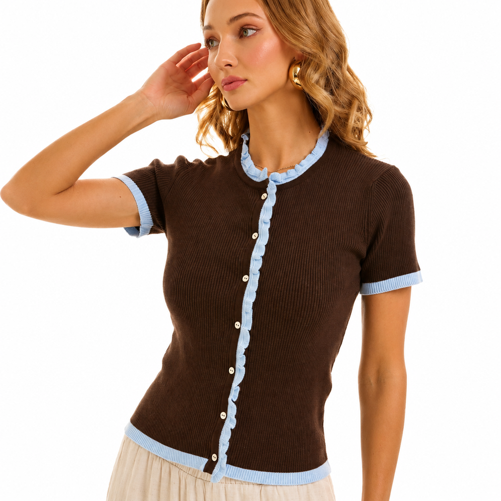 A woman wearing a brown short-sleeve ribbed knit top with light blue trim on the collar, cuffs, hem, and front button placket, photographed against a plain white studio background.
