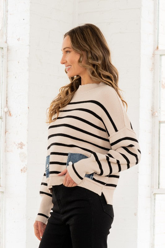 Woman wearing a striped sweater against a white background