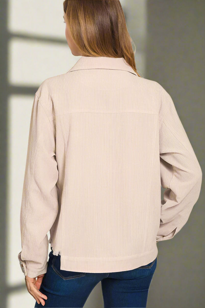 Beige jacket worn by a person on a white background