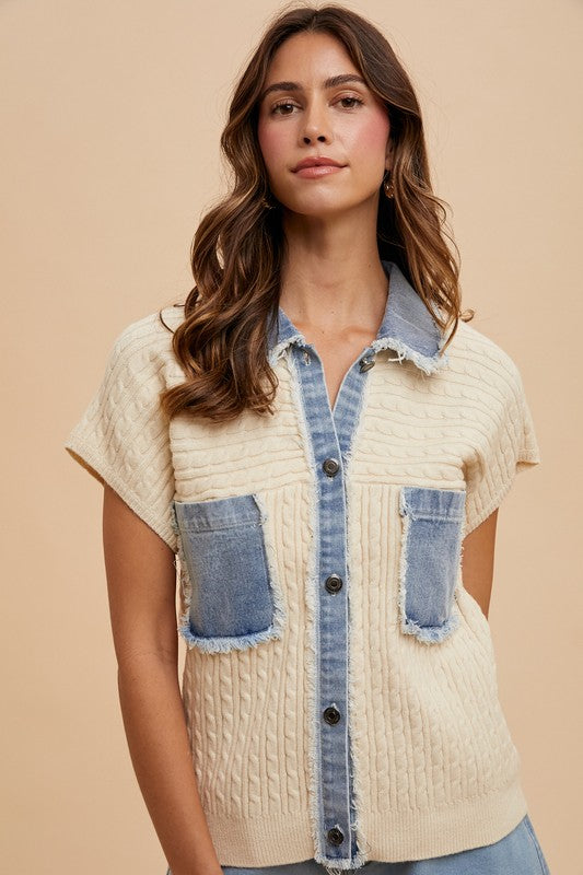 Woman wearing a beige textured shirt with denim accents on a beige background