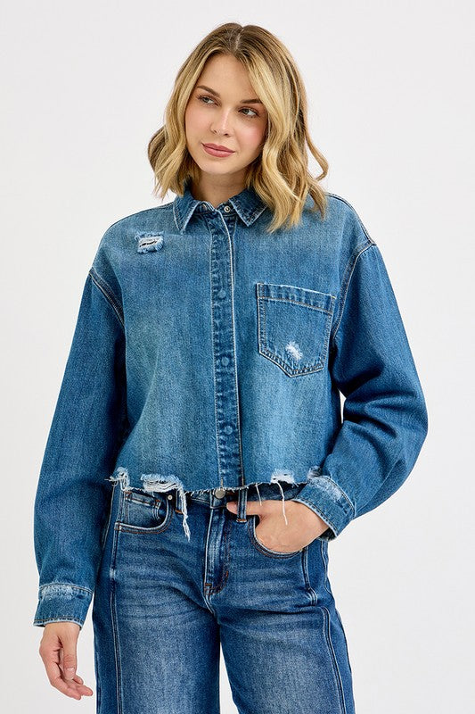 Woman wearing a blue denim jacket and jeans on a white background