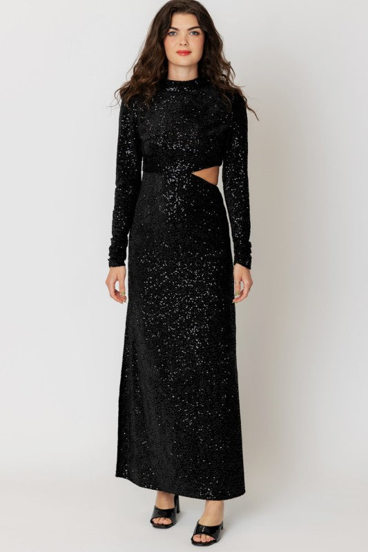 Woman wearing a black sequin dress with cut-out design on a white background