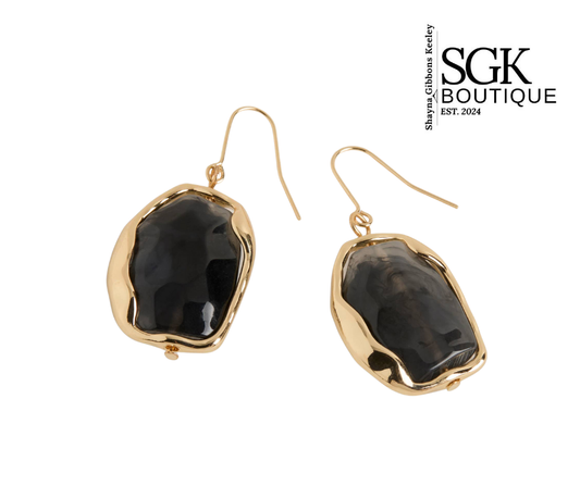 Gold earrings with black stones on a white background, featuring SGK Boutique logo.