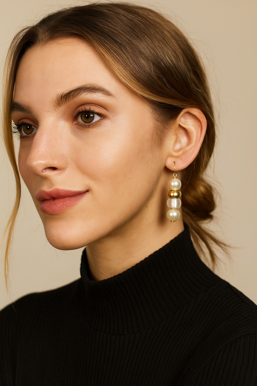 Woman wearing pearl earrings with a neutral background