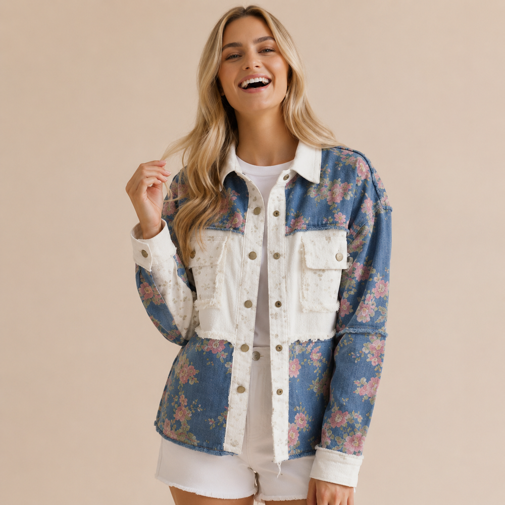 Woman wearing a floral denim jacket on a beige background